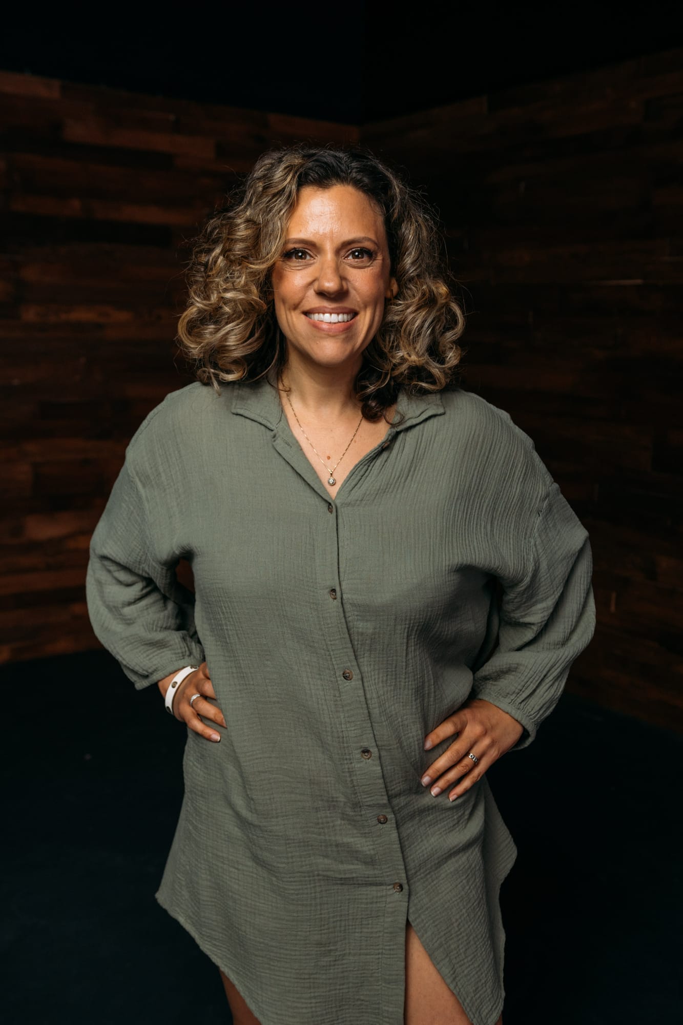 Trisha Miltimore corporate story frame 1: Personal-brand portraits for Trisha Miltimore in Kelowna, moving from clean business profile images into darker wood-wall portraits with black wardrobe and confident brand range..