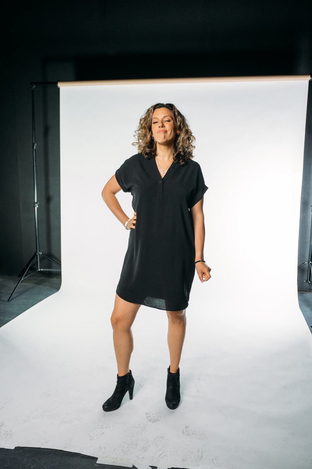 Trisha Miltimore corporate story frame 14: Personal-brand portraits for Trisha Miltimore in Kelowna, moving from clean business profile images into darker wood-wall portraits with black wardrobe and confident brand range..