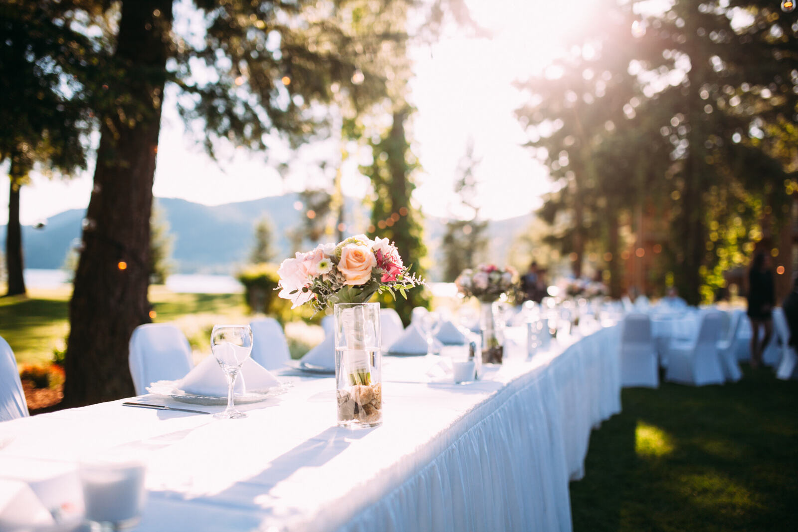 Long outdoor wedding reception table in warm evening light