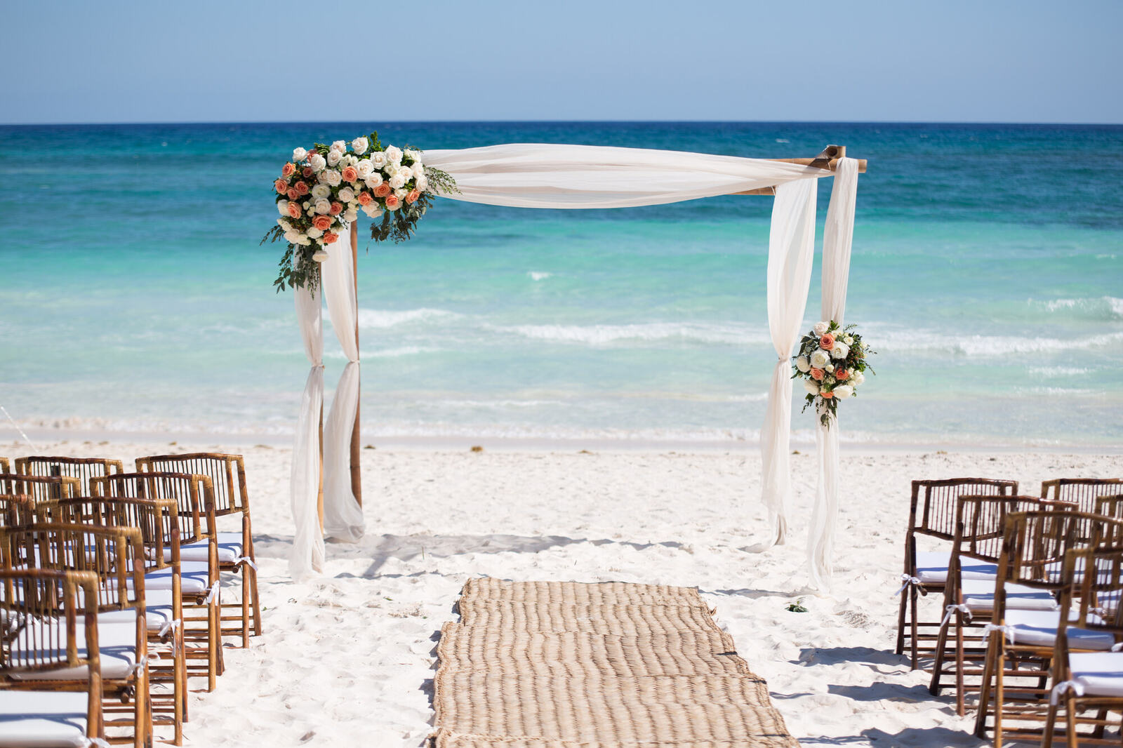 Beach wedding ceremony arch in Mexico with turquoise water